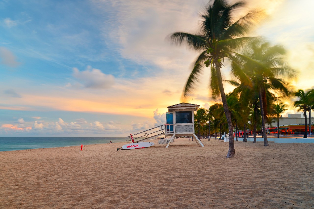 524399815 Sunset at Sunrise Beach in Ft.Lauderdale with palm trees and beach entry feature.